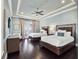 Spacious bedroom with dark wood floors, light blue walls, two beds and access to the balcony at 971 Golden Bear Dr, Reunion, FL 34747