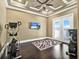 Bright exercise room features hardwood floors, TV and French doors to the outside at 971 Golden Bear Dr, Reunion, FL 34747