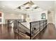 Elegant foyer with dark wood floors, wrought iron railing and stunning decorative ceiling at 971 Golden Bear Dr, Reunion, FL 34747