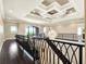 Elegant foyer with dark wood floors, wrought iron railing and stunning decorative ceiling at 971 Golden Bear Dr, Reunion, FL 34747