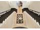 Grand foyer with dual staircases, decorative iron railings, and a striking circular display table with flowers at 971 Golden Bear Dr, Reunion, FL 34747