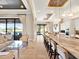 Open-concept kitchen featuring an island with seating, seamlessly connects to the living area and outdoor views at 971 Golden Bear Dr, Reunion, FL 34747