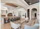 Open-concept kitchen and seating area, with a large kitchen island, modern lighting, and stainless steel appliances at 971 Golden Bear Dr, Reunion, FL 34747