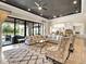 Spacious living room with a decorative rug, comfortable seating, and sliding glass doors to the outside at 971 Golden Bear Dr, Reunion, FL 34747