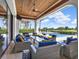 Cozy outdoor living space with comfortable seating, a ceiling fan, and a view of the pool and backyard at 971 Golden Bear Dr, Reunion, FL 34747