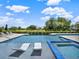 Relaxing backyard pool with in-pool loungers and a spa, perfect for outdoor entertaining at 971 Golden Bear Dr, Reunion, FL 34747