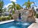 Fantastic pool features a stone grotto with a slide and waterfall for added backyard fun at 971 Golden Bear Dr, Reunion, FL 34747