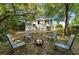 Spacious backyard featuring chairs around a fire pit, with a house in the background at 992 Woodrose Ct, Altamonte Springs, FL 32714