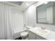 Bright bathroom featuring a tub with shower, white tile surround, modern vanity and white sink at 992 Woodrose Ct, Altamonte Springs, FL 32714