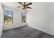 Bright bedroom with neutral decor and views to the outdoors from two windows at 992 Woodrose Ct, Altamonte Springs, FL 32714