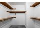 Walk-in closet features multiple wooden shelves for optimal organization and storage at 992 Woodrose Ct, Altamonte Springs, FL 32714