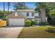 Charming two-story home featuring a brick chimney, attached two-car garage, and well-maintained landscaping at 992 Woodrose Ct, Altamonte Springs, FL 32714