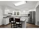 Well-lit kitchen featuring white cabinets, stainless steel appliances, and a center island with bar seating at 992 Woodrose Ct, Altamonte Springs, FL 32714