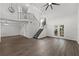 Open-concept living room with modern lighting, staircase, and sliding doors leading to the outdoor area at 992 Woodrose Ct, Altamonte Springs, FL 32714