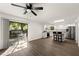 Open concept living area with ceiling fan offers views to the outdoor patio and kitchen at 992 Woodrose Ct, Altamonte Springs, FL 32714