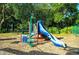 Community playground featuring modern slide and climbing structure in a wooded common area at 992 Woodrose Ct, Altamonte Springs, FL 32714