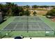 Aerial view of the community tennis courts surrounded by lush landscaping at 992 Woodrose Ct, Altamonte Springs, FL 32714