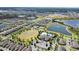 Expansive aerial view showcasing the community's layout with lakes, a pool, and well-manicured green spaces at 10006 Quail Meadow Aly, Winter Garden, FL 34787