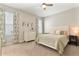 Comfortable bedroom features a ceiling fan, carpeted flooring, and bright windows at 10006 Quail Meadow Aly, Winter Garden, FL 34787