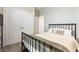 Cozy bedroom with a black metal bed frame and direct access to the hall and closet at 10006 Quail Meadow Aly, Winter Garden, FL 34787