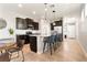 Stylish kitchen with dark cabinetry, granite countertops, and stainless steel appliances at 10006 Quail Meadow Aly, Winter Garden, FL 34787