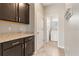Practical laundry room features a granite countertop, storage cabinets, and a modern washer and dryer at 10006 Quail Meadow Aly, Winter Garden, FL 34787