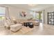 Bright living room features tile flooring, neutral tones, and sliding glass doors to the patio at 10006 Quail Meadow Aly, Winter Garden, FL 34787