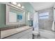Well-lit bathroom features a granite countertop and tiled shower/tub combination at 1008 W Riviera Blvd, Oviedo, FL 32765