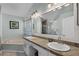 Bathroom with double sinks, a soaking tub, and a large mirror at 1008 W Riviera Blvd, Oviedo, FL 32765