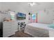 Bedroom featuring wood-look floors, a TV, and shelving with bright window at 1008 W Riviera Blvd, Oviedo, FL 32765