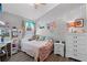 Inviting bedroom with wood-look flooring, ample light, and space for relaxation at 1008 W Riviera Blvd, Oviedo, FL 32765