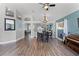 Open-concept dining area featuring wood floors, chandelier, and seamless flow to other living spaces at 1008 W Riviera Blvd, Oviedo, FL 32765