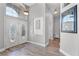 Elegant foyer with soaring ceilings, wood-look floors, and a decorative front door at 1008 W Riviera Blvd, Oviedo, FL 32765