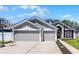 Charming home featuring a three-car garage, neutral color palette and a basketball hoop at 1008 W Riviera Blvd, Oviedo, FL 32765