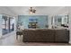 Cozy living room featuring a media center, comfortable sofa, and seamless access to the outdoors at 1008 W Riviera Blvd, Oviedo, FL 32765