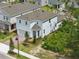 New two-story home featuring a brick driveway, landscaping, and a well-maintained lawn at 1096 Happy Forest Loop, Deland, FL 32720