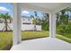 Covered back porch overlooking a landscaped backyard with privacy fence and greenery at 1096 Happy Forest Loop, Deland, FL 32720