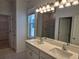 Stylish bathroom featuring double sinks, a large mirror, and a walk-in shower with modern fixtures at 1096 Happy Forest Loop, Deland, FL 32720