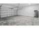 Spacious garage with concrete floor, overhead door, and water heater at 1096 Happy Forest Loop, Deland, FL 32720