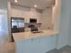 Bright kitchen boasts white cabinetry, stainless steel appliances, quartz countertop and an island sink and faucet at 1096 Happy Forest Loop, Deland, FL 32720