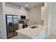 Modern kitchen featuring white cabinets, stainless steel appliances, and a sleek countertop with an island sink at 1096 Happy Forest Loop, Deland, FL 32720