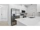 Modern kitchen features stainless steel appliances, white cabinets, quartz countertops, and tile backsplash at 1096 Happy Forest Loop, Deland, FL 32720