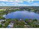 Aerial view showcases a waterfront homesite with mature trees and access to the tranquil lake at 1105 Lake Nettie Dr, Eustis, FL 32726