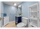 Charming blue bathroom featuring a vanity with storage and a stylish mirror at 1105 Lake Nettie Dr, Eustis, FL 32726