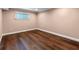 Neutral bedroom showing window, baseboards and hardwood floors at 1105 Lake Nettie Dr, Eustis, FL 32726