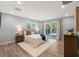 Bright bedroom featuring sliding glass doors and neutral decor at 1105 Lake Nettie Dr, Eustis, FL 32726
