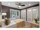 Charming bedroom featuring a cozy window seat, modern ceiling fan, and spacious closet at 1105 Lake Nettie Dr, Eustis, FL 32726