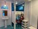 Changing room with sink, mirror, and adjacent changing stalls with storage at 1105 Lake Nettie Dr, Eustis, FL 32726