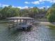Private dock with boat lift on a tranquil lake at 1105 Lake Nettie Dr, Eustis, FL 32726