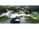 Waterfront home featuring a covered dock, beach area and wooded area with multi-story home at 1105 Lake Nettie Dr, Eustis, FL 32726
